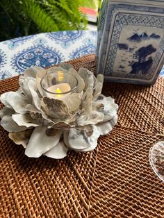 a candle is sitting on top of a wicker table