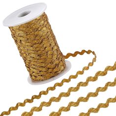 a spool of gold glittered ribbon next to a roll of metallicized twine