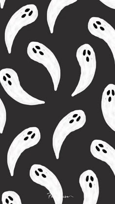 a black and white pattern with ghost faces