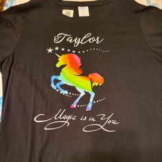 Black Tshirt With Colorful Unicorn Design, Name Taylor And Says "Magic Is In You". Size Medium. Black Crew Neck T-shirt With Rainbow Print, Multicolor Cotton T-shirt With Unicorn Print, Multicolor Unicorn Print Crew Neck T-shirt, Cotton Graphic Tee With Unicorn Print, Fun Cotton T-shirt With Unicorn Print, Colorful Unicorn, Sublimation Shirt, Company Shirts, Design Name