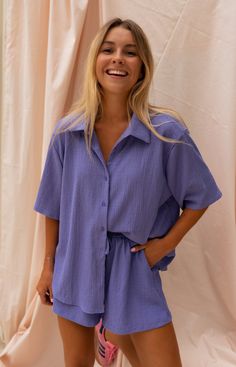 Purple short sleeve button up shirt that is light and flowy which is perfect for those hot summer days/nights! Such an easy, versatile shirt that can be styled and dressed up or down no matter the occasion. Pair our Bekki Shirt with any bottoms including our matching Harold Shorts for a full-set look! Our model wears the Purple Harold Shorts and the Light Blue Hunter Jeans Matching set: Purple Harold Shorts Not transparent Sizes: S / M / L S: Length 25.59 in - Width 23.62 in M: Length 26.38 in - Matching Button Up And Shorts, Cute Hawaii Outfits, Hot Summer Day Outfit, Matching Set Outfit Summer, Cotton Gauze Pants, Lavender Shirt, Pastel Shirt, Zebra Print Skirt, Purple Beach