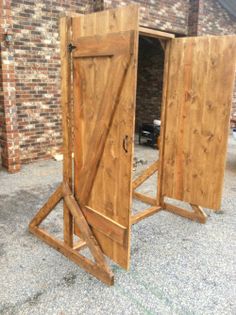 two wooden doors are open in front of a brick building