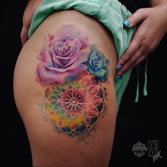 a woman's thigh with a rose tattoo on it