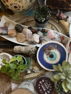 a table topped with plates and bowls filled with rocks