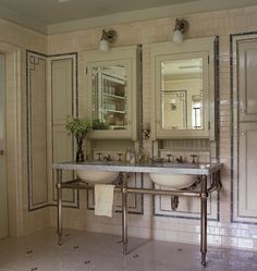 a bathroom with two sinks and mirrors in it