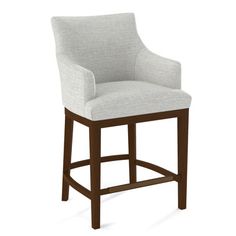 an upholstered bar stool with armrests in grey fabric and walnut wood frame