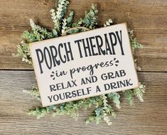 a sign that says porch therapy in progress relax and grab yourself a drink on the table