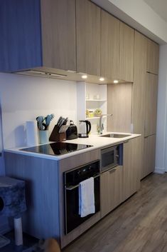 a kitchen with an oven, sink and microwave inside of it's cabinetry