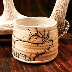 a ceramic animal mug sitting on top of a wooden table