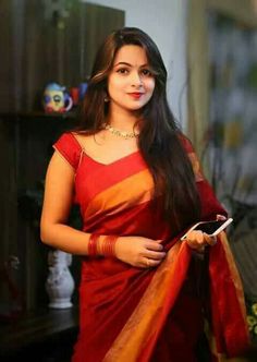 a woman in a red and orange sari