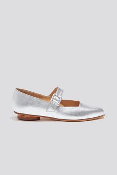 The Eugenia Flat is a modern interpretation of the classic mary jane flat featuring a square toe, angular topline and oval-shaped heel. This pair is crafted from metallic silver kidskin leather and a matching buckle.  Who it's for: The woman who is looking for mood-enhancing emotional pieces that defy reason, yet work perfectly with her style and sense of expression.  Kidskin upper and undyed vegetable-tanned leather lining. Leather sole with stacked leather heel measuring 18mm. Handmade in Argentina Silver Closed Toe Leather Flats, Silver Closed Toe Flats With Leather Sole, Silver Leather Almond Toe Flats, Classic Silver Flats With Round Toe, Silver Classic Flats For Spring, Classic Silver Flats For Spring, Womens Mary Janes, Mary Jane Flats, Etsy Fashion