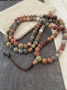 Matte Jasper mala necklace, a unique unisex earthy 108 mala necklace that you can rock with your everyday outfit, can be a layering necklace and you can use it also while meditating. A unisex item that is a great gift for yourself and a love one. The mala necklace has a drop lenght of: 17 inch  (without the tassels) ,  No Clasp. A most have addition to your gemstone jewelry collection. ⚡️GET 20% OFF NOW⚡️ JOIN AKASHI'S VIP LIST and Shop ⚡️Join Akashi's VIP list for early bird discount access⚡️ P Bohemian Beaded Bracelets For Meditation, Agate Beaded Bracelets With 108 Beads For Meditation, Bohemian Jasper Beaded Bracelets For Healing, Multicolor Mala With 8mm Beads, Artisan Adjustable Mala With 108 Beads, Healing Jasper Beaded Bracelets With 8mm Beads, Beaded Jasper Bracelets With Gemstone Beads, Jasper Gemstone Beaded Bracelets, Jasper Gemstone Beads Bracelet