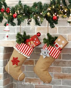 christmas stockings hanging from a mantel with presents