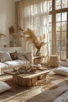 a living room filled with lots of furniture and pillows on top of a wooden table