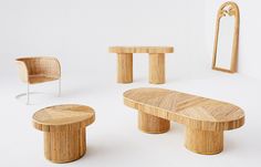 an assortment of wooden furniture including a table, chair and mirror with white walls in the background