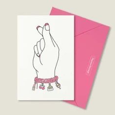 a pink card with a drawing of a hand holding a key on it's wrist