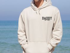 "Disclaimer: This listing provides hoodies for adults and kids. The kids hoodies do not include drawstrings due to safety regulations. Fathers Day Hoodie, Daddy Hoodie, Personalised Dad, Father's Day Gift, Custom Dad Hoodie, Dad Birthday Gift, Best Dad Jumper, New Dad Gift Our hoodies are Gildan branded. Material :  Unisex Hoodies...80% ringspun cotton / 20% polyester: Black, white, navy, maroon, sport grey,light pink, red, royal blue, yellow haze, stone blue,dark grey heather, sand, paragon, ch New Dad Gift, Small Wardrobe, Dad Fashion, Wardrobe Update, Gifts For New Dads, Dad Life, Grey Light, Eco Friendly Fashion, Dad Birthday Gift