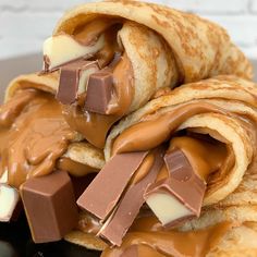 chocolate and marshmallows are stacked on top of each other with crepes