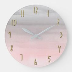 a pink and gold clock with numbers on the face is shown against a white background