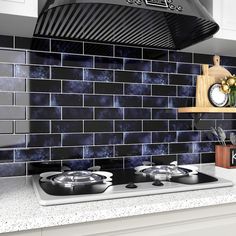 a stove top oven sitting inside of a kitchen next to a wall mounted range hood