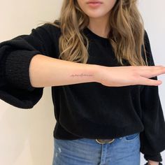 a woman is holding out her hand with the word love written on it in cursive writing