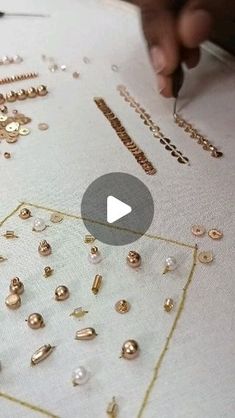 someone is working on some gold jewelry with their fingers and thumbnails in front of them