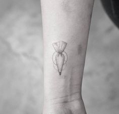 a small tattoo on the wrist of a woman