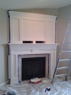 a fire place being painted with white paint