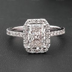 an engagement ring with a cushion cut diamond in the center and pave diamonds around it