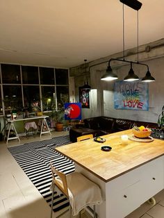 a kitchen island with two chairs and a table