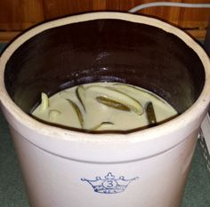 a bucket filled with liquid sitting on top of a counter