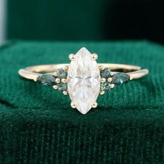 an oval cut diamond ring with three pear shaped diamonds