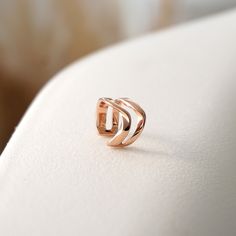 Inspired by our popular Amor and Amos rings, the design of our Linea Ear Cuff features two twisting bands that flow in parallel with one another. The delicate scale of this design invokes a quiet beauty for a modern effortless look. Dimensions: 0.6" diameter x 0.3" width Available in: Sterling Silver, 18K Rose Gold Vermeil Includes: One ear cuff and a custom felt pouch Modern Hypoallergenic Open Band Jewelry, Modern Rose Gold Open Band Jewelry, Elegant Adjustable 14k Gold Ear Cuff, Adjustable Twisted Modern Jewelry, Modern Adjustable Twisted Jewelry, Elegant Open Ring Ear Cuff For Everyday, Elegant Rose Gold Ear Cuff For Everyday, Minimalist Ear Cuff For Anniversary, Modern Twisted Jewelry For Everyday