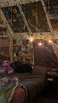 a bed room with a neatly made bed and lots of decorations on the ceiling above it