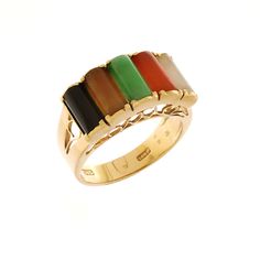 a gold ring with four different colored stones