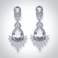 An exquisite bridal earrings design that will add a touch of sophistication to any wedding gown or formal ensemble. Adorned with flawlessly faceted cubic zirconia that capture the light in a dazzling array of sparkles, the earrings are rhodium / rose gold plated for a bright finish which enhances the intricate detailing and conveys a modern take on old elegance. Length: 2.3" (approx. 6cm; Width: 0.9" (approx. 2.4cm); Weight: 7.8g. Available in Silver and Rose Gold finishes. To make your choice s Glamorous Wedding Diamond Earrings With Diamond Accents, Glamorous Wedding Diamond Earrings With Accents, Glamorous Diamond Wedding Earrings, Glamorous Diamond Earrings For Wedding, Exquisite Diamond White Crystal Earrings, Glamorous Wedding Crystal Earrings With Diamond Accents, Wedding Cubic Zirconia Earrings With Diamond Accents, Exquisite Bridal Drop Earrings With Diamond Accents, Glamorous Diamond White Cubic Zirconia Earrings