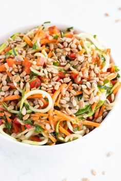 a white bowl filled with veggie salad on top of a table