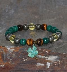 Malachite, Pyrite, Citrine and Tigers Eye Bracelet* IMPORTANT: ♥ When your select your size (from the drop-down box) let me know the exact measure of your wrist without adding extra length please. I will do it and you will get a perfect fit! ;) For any question do not hesitate to contact me and I will answer you quickly. ♥ Each piece comes in a delicate pouch. These bags are ideal to preserve the jewel in perfect conditions and are the ideal wrap to present as a gift to that special person. ♥ Al Good Luck Adjustable Beaded Bracelets With Natural Stones, Adjustable Gemstone Beads Bracelets For Good Luck, Spiritual Beaded Bracelets With Natural Stones For Good Luck, Spiritual Charm Bracelet With Natural Stones, Healing Charm Bracelet With Natural Stones And Round Beads, Good Luck Gemstone Beaded Bracelets, Hand-strung Charm Bracelet With Round Beads For Healing, Green Beaded Bracelets For Good Luck, Beaded Clover