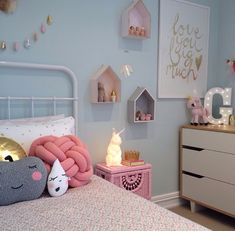 a child's bedroom decorated in pastel blue and pink