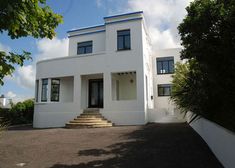 a white house with steps leading up to it