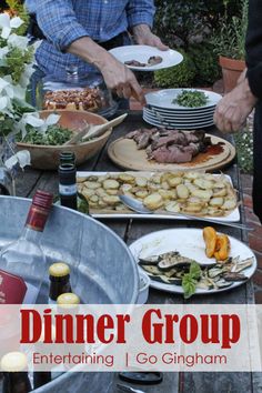 a table full of food and wine with people standing around it that says dinner group entertaining i go gingham