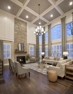 a living room filled with furniture and a fire place in the middle of a room