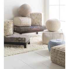 a living room filled with lots of different types of furniture and decor on top of a white rug