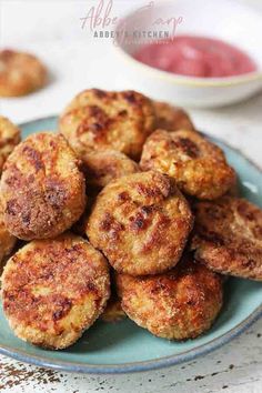 some fried food on a blue plate with dipping sauce