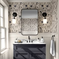 a bathroom vanity with two sinks and a large mirror above it, in front of a window