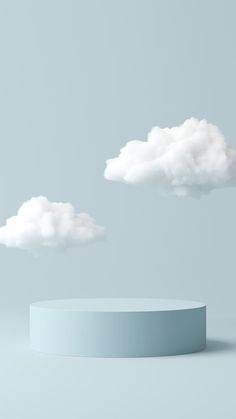 two white clouds floating in the sky above a round object on a gray background with copy space