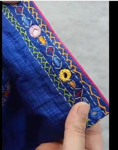 someone is stitching something on the edge of a piece of cloth