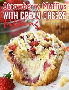 strawberry muffins with cream cheese filling and strawberries in the background on a paper plate