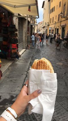 a person holding up a piece of food in their hand