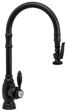 a kitchen faucet with black handles and an overflowing spigot